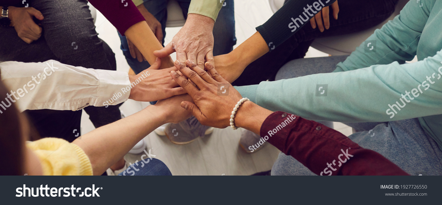 People of different ages and nationalities fold their hands on each other, symbolizing their unity and support. Team of people who are set up for productive work and a positive result. Close up. #1927726550