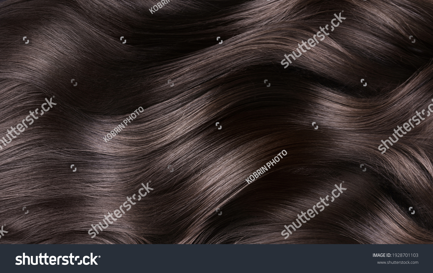A closeup view of a bunch of shiny curls brown hair. #1928701103