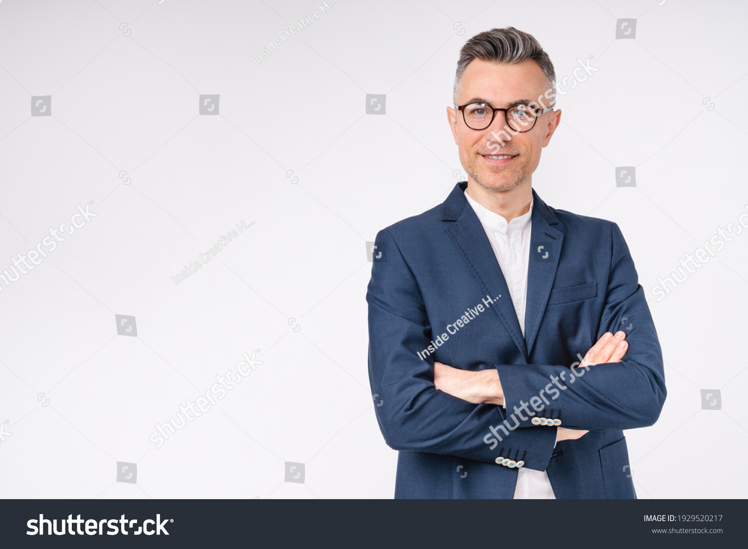 Good-looking middle-aged businessman with arms crossed isolated in white background #1929520217