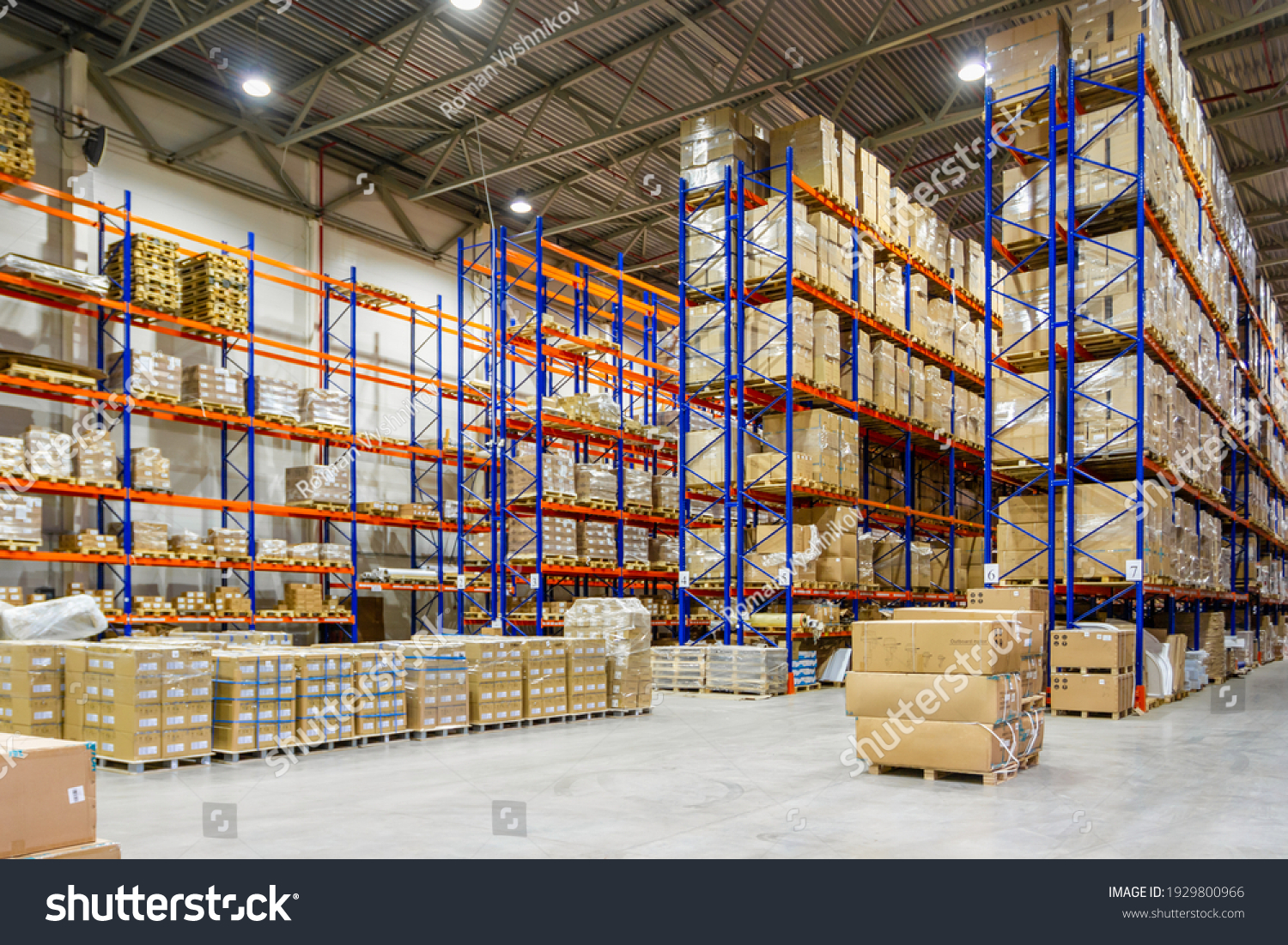 Interior of a modern warehouse storage of retail shop with pallet truck near shelves #1929800966