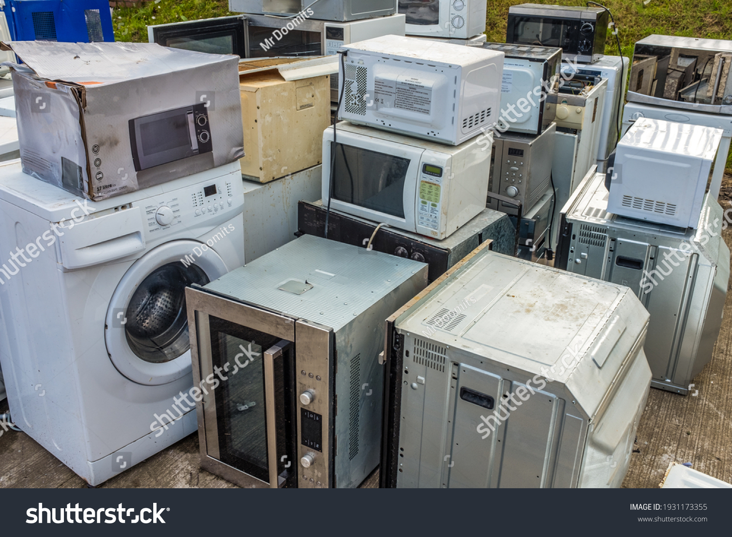 A Collection Of Domestic Applicance (Ovens, Microwaves And Washing Machines) Left At A Dump Or Recycling Center #1931173355