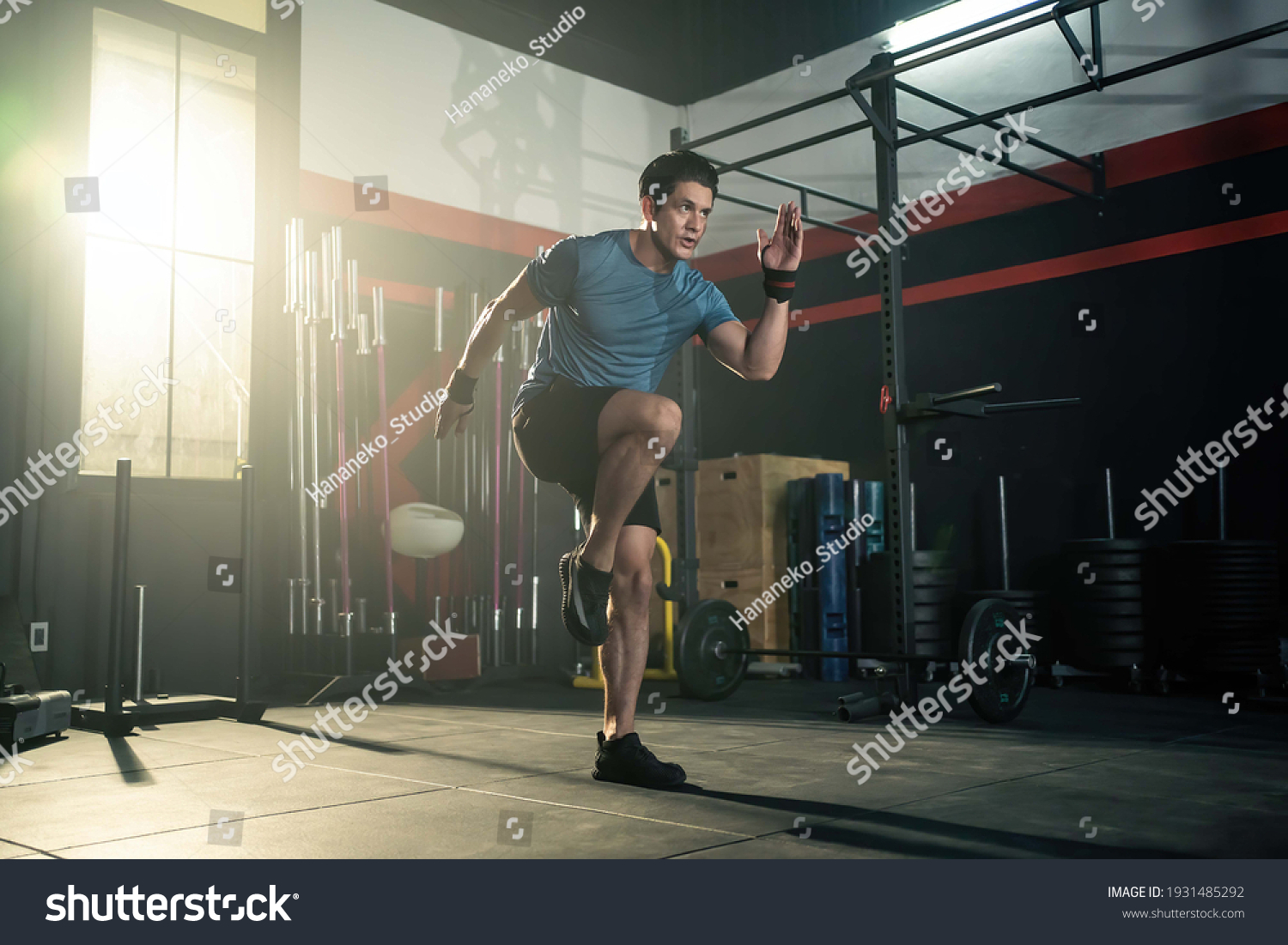 Strong young athlete fit man running in fitness gym. The man with sportswear showing his strength muscular in body. Bodybuilding exercise and sport workout training concept. #1931485292