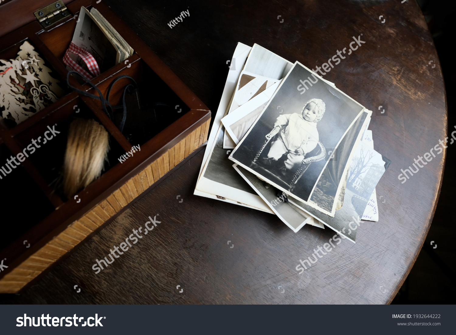 dear to heart memorabilia in an old wooden box, a stack of retro photos, vintage photographs of 1960, concept of family tree, genealogy, connection with ancestors #1932644222