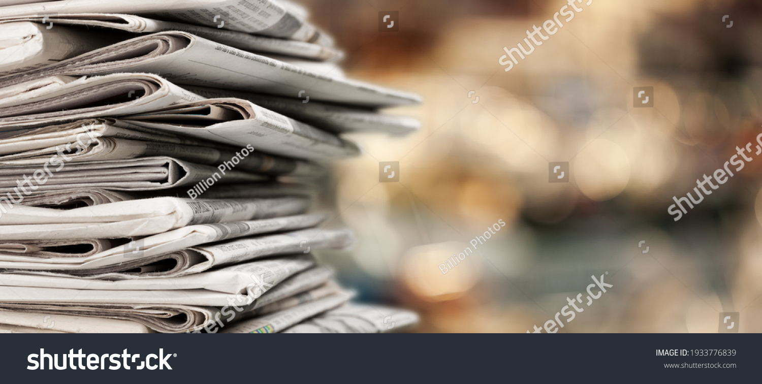 Pile of newspapers stacks on blur background #1933776839