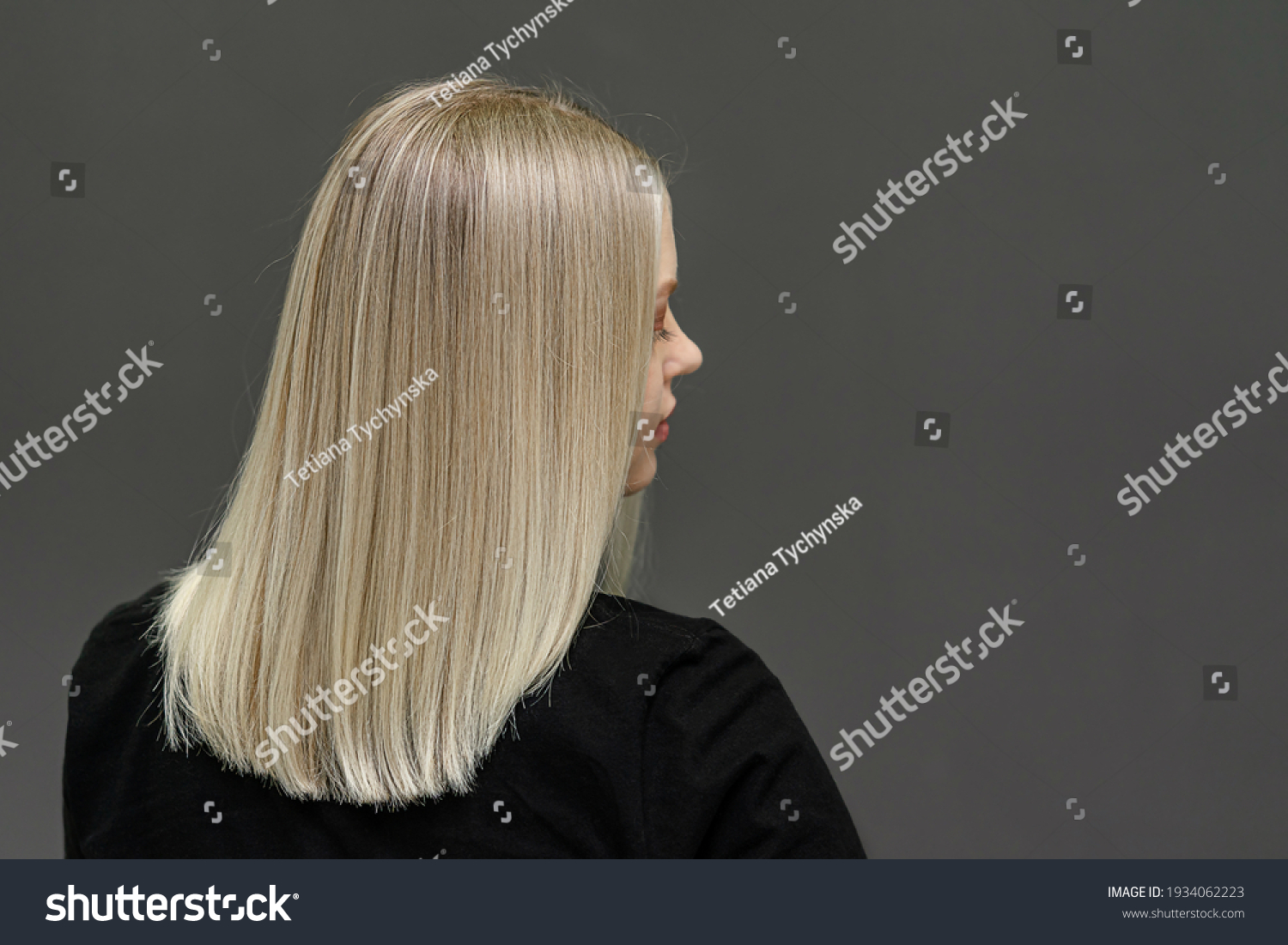 Blonde model with straight hair, look from behind. Hair bleaching result. Space for text #1934062223