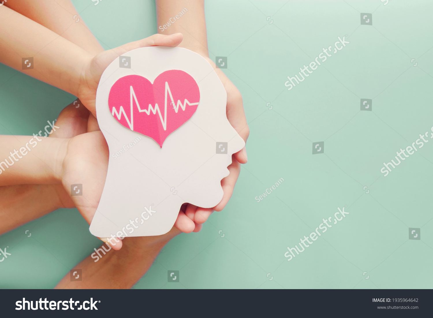 Adult and children hands holding paper brain and heart, brain stroke, world heart day, world mental health day, Alzheimer and wellness concept #1935964642