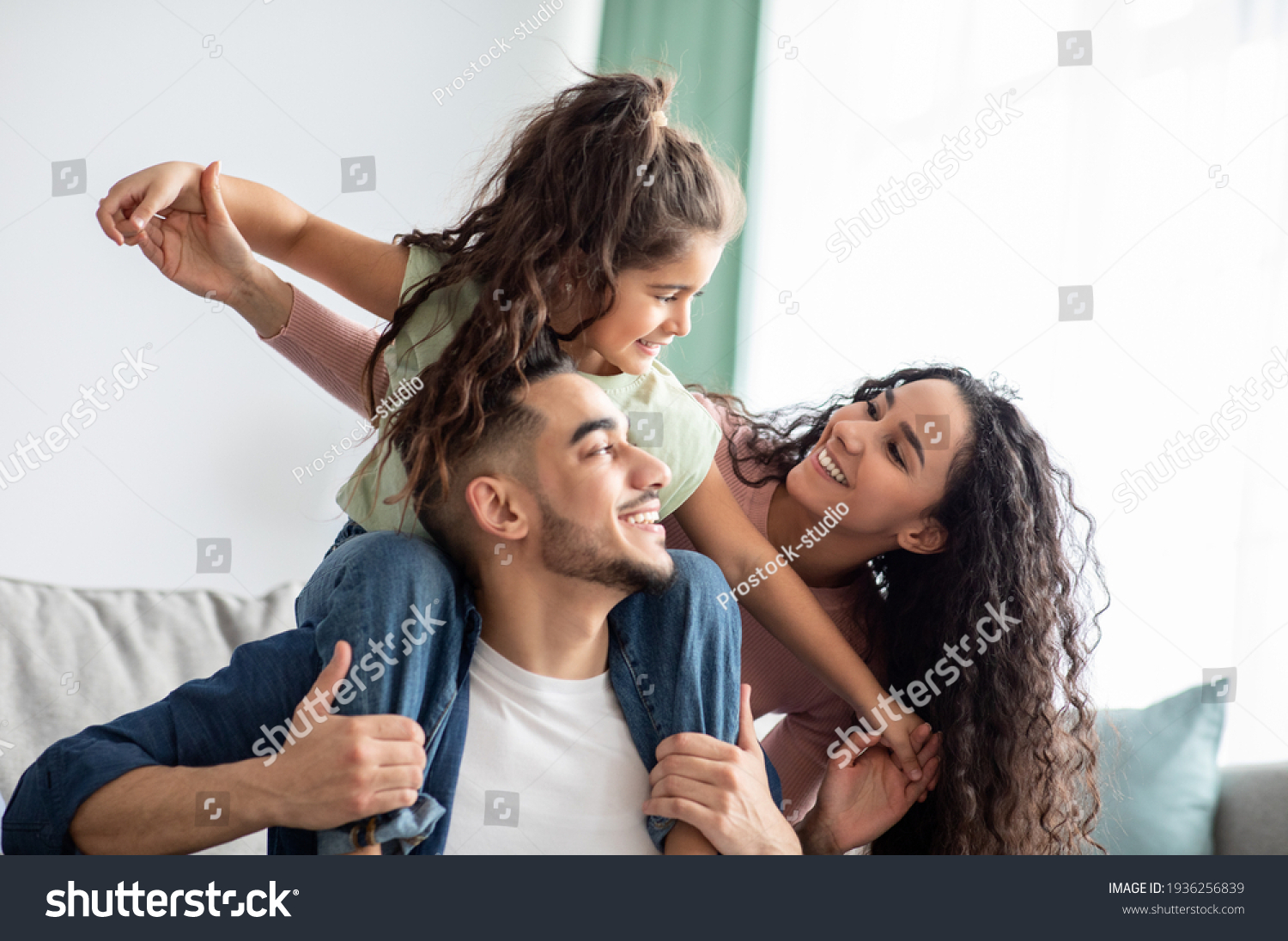 Cheerful Middle Eastern Family Of Three Having Fun Together At Home #1936256839
