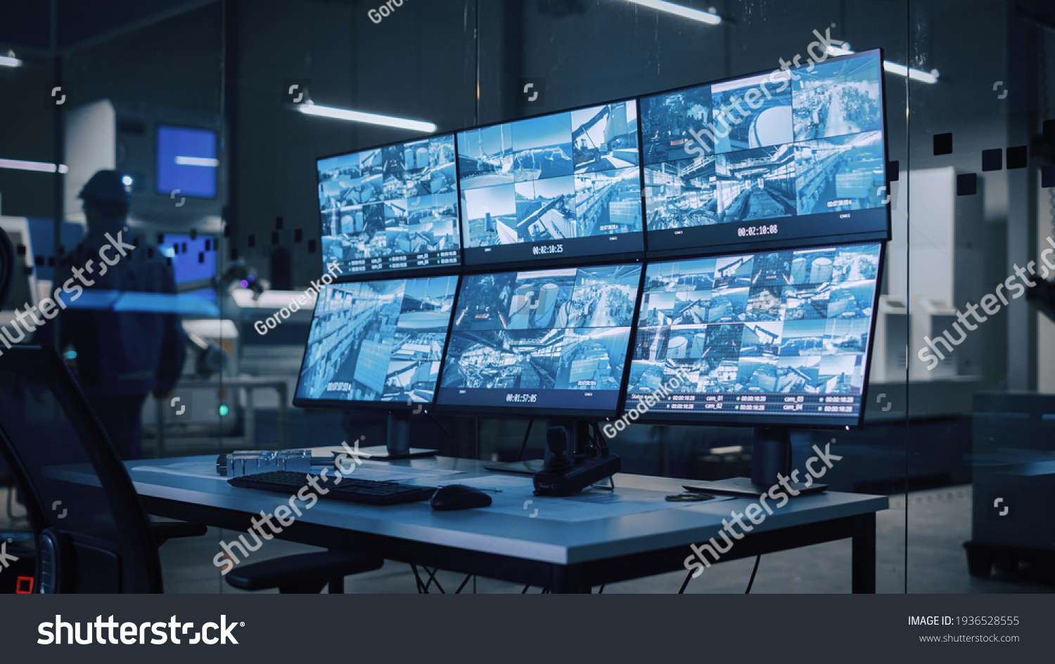 Industry 4.0 Modern Factory: Security Control Room with Multipoke Computer Screens Showing Surveillance Camera Footage Feed. High-Tech Security #1936528555