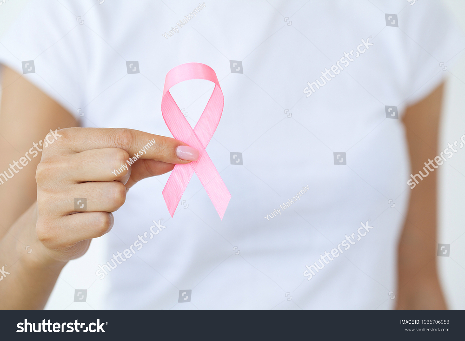 Close up of woman showing pink ribbon symbolizing breast cancer #1936706953