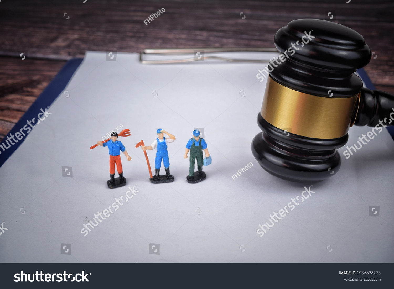 Selective focus image of gavel with miniature of labor. Labor law concept.  #1936828273