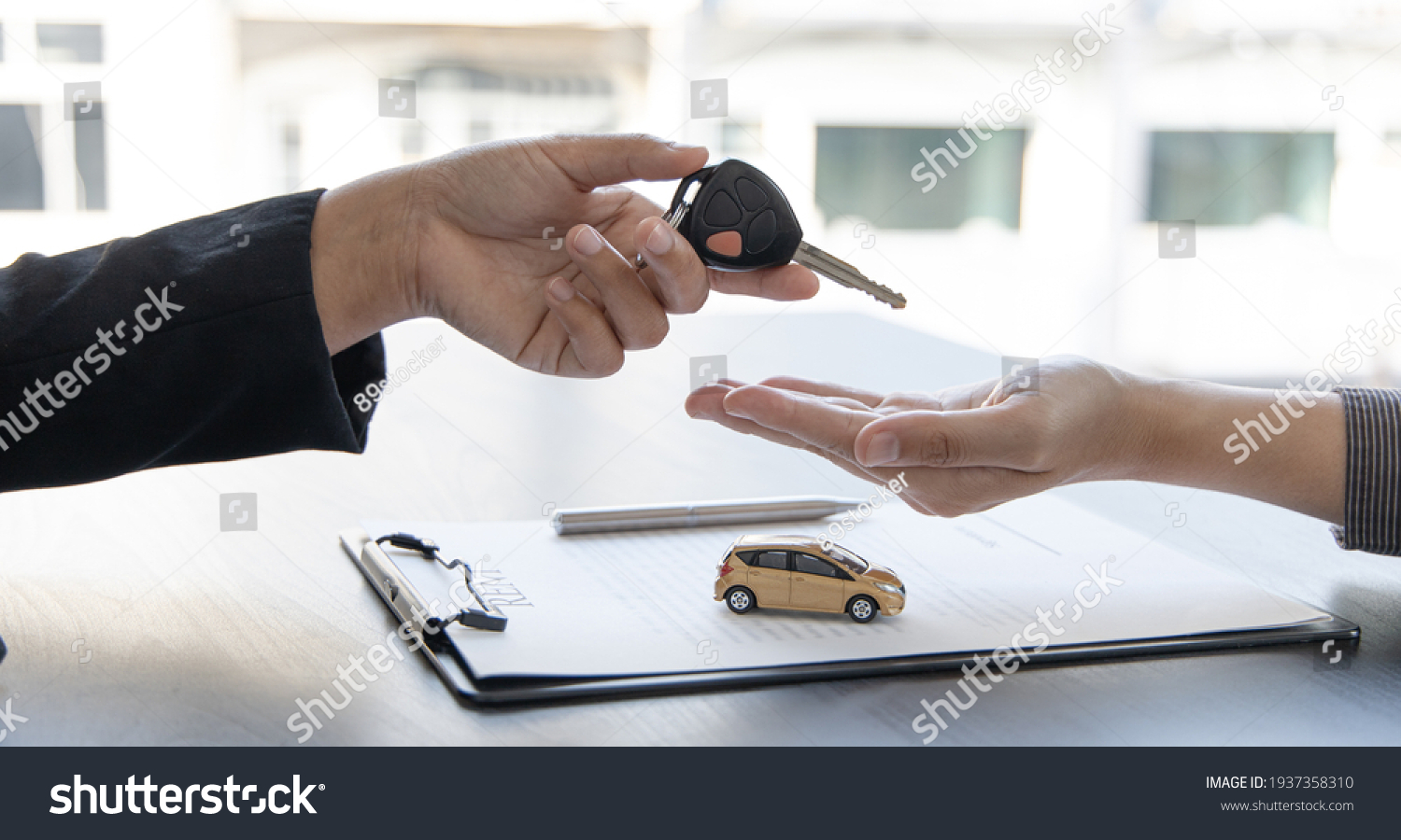 Car salesman gave the keys to the customers who signed the purchase contract legally, Successful completion of car sales, Purchase contract and key delivery. #1937358310