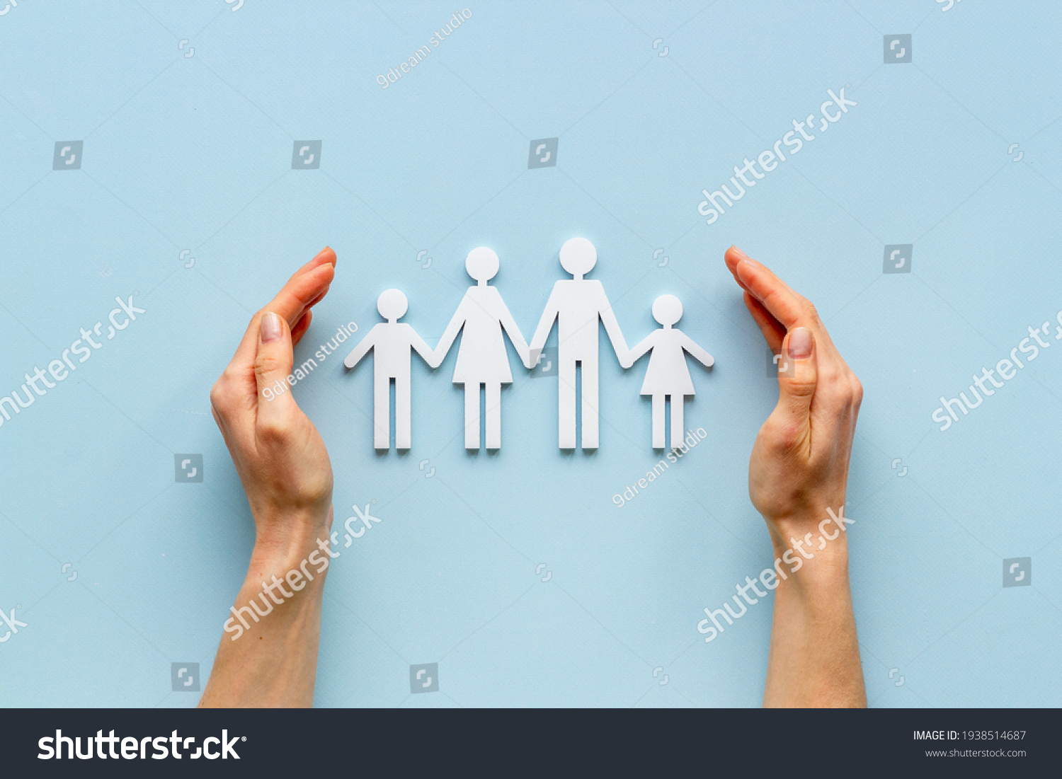 Hands holding family figure top view. Insurance concept #1938514687