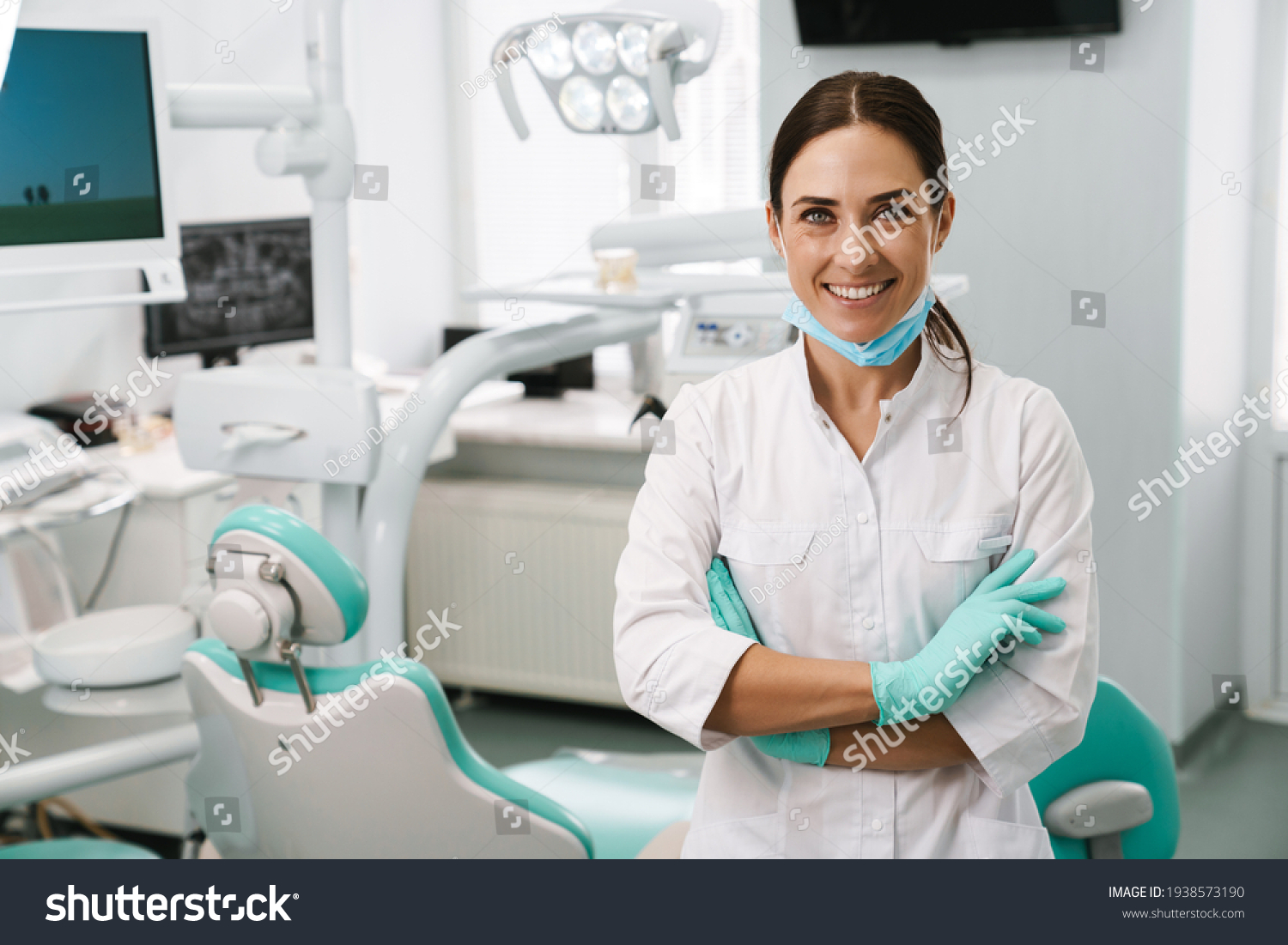 European mid dentist woman smiling while standing in dental clinic #1938573190