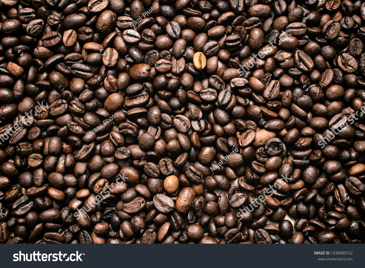Coffee beans. Coffee beans are spread out on the surface. #1938980152