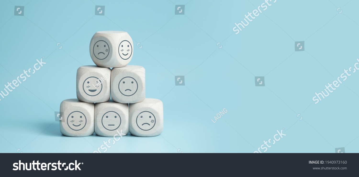 world mental health day concept or feedback rating and positive customer review, wood cube stacking with emotion face icon on blue background #1940973160