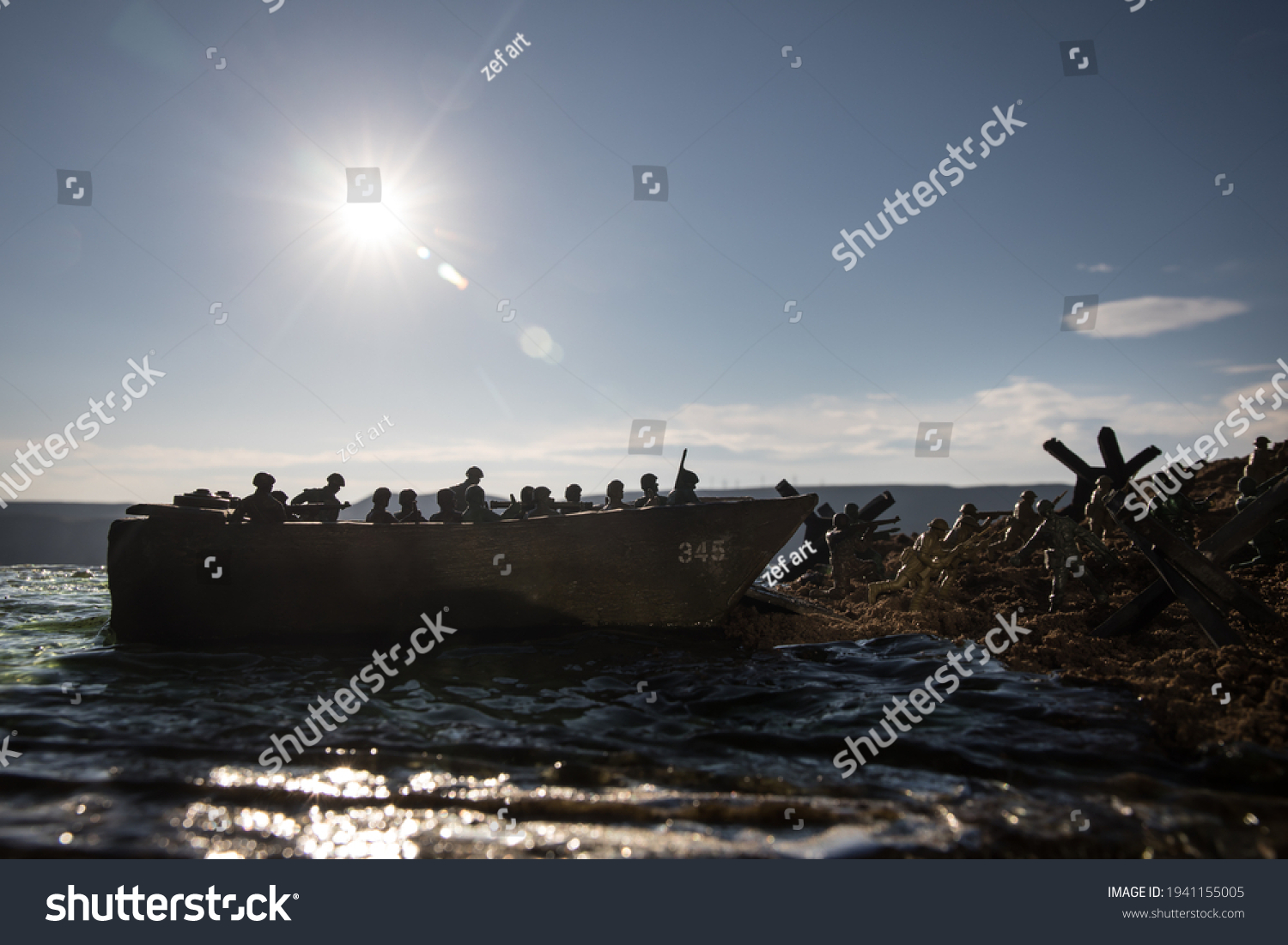 World War 2 reenactment (D-day). Creative decoration with toy soldiers, landing crafts and hedgehogs. Battle scene of Normandy landing on June 6, 1944. Selective focus #1941155005