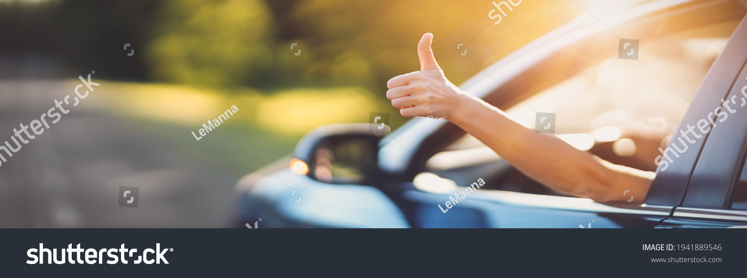 Woman inside her car gesticulate thumb up #1941889546