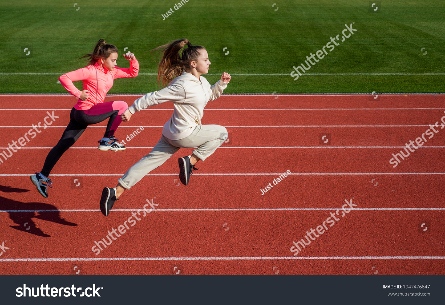 stamina. teenage girls run marathon. runner on race competition. sprinter warming up on stadium gym. children training at school physical education lesson. speed and motion. Just flying #1947476647