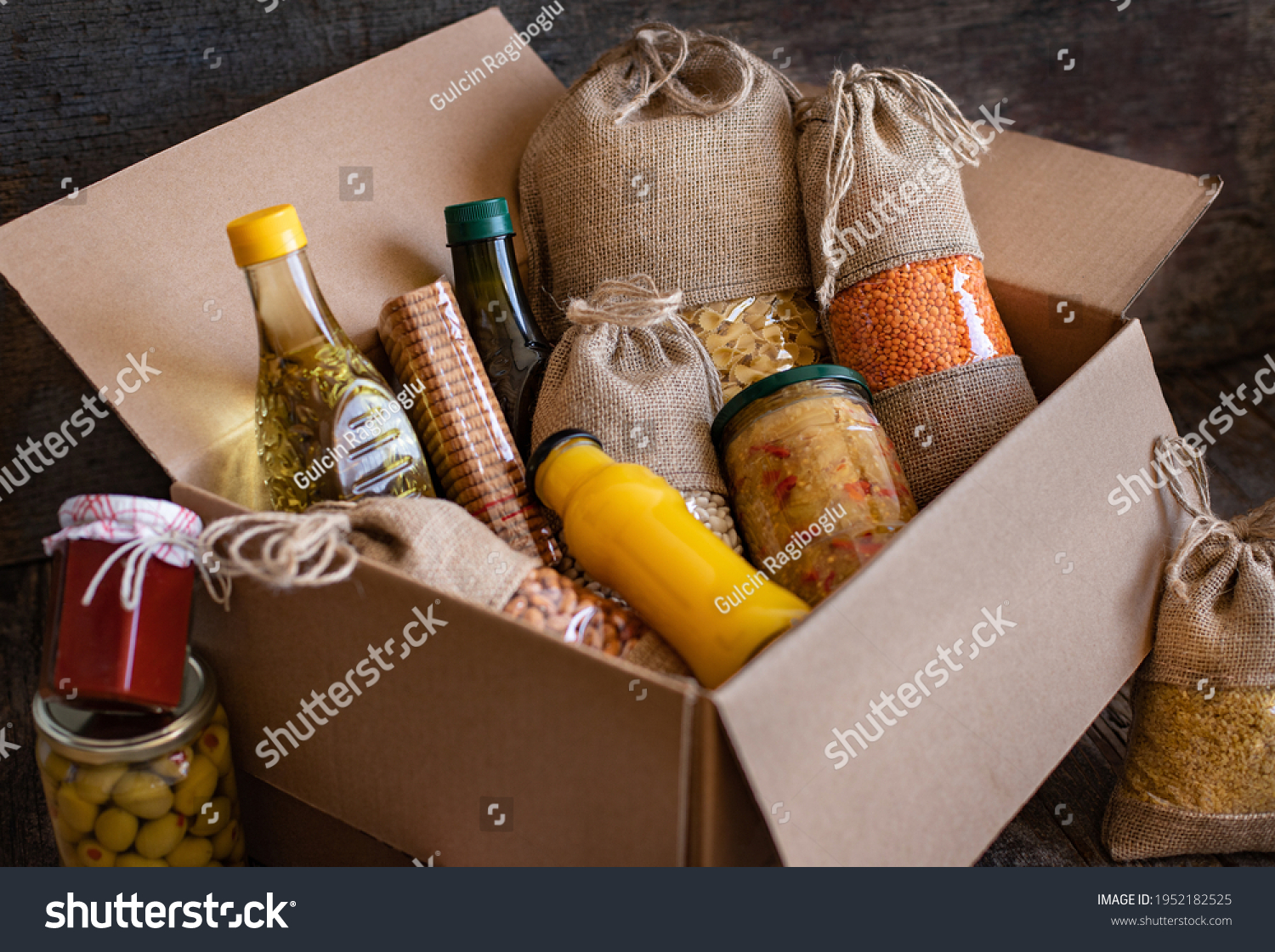 Volunteer with box of food for poor. Donation concept. Many foods in the package.  #1952182525