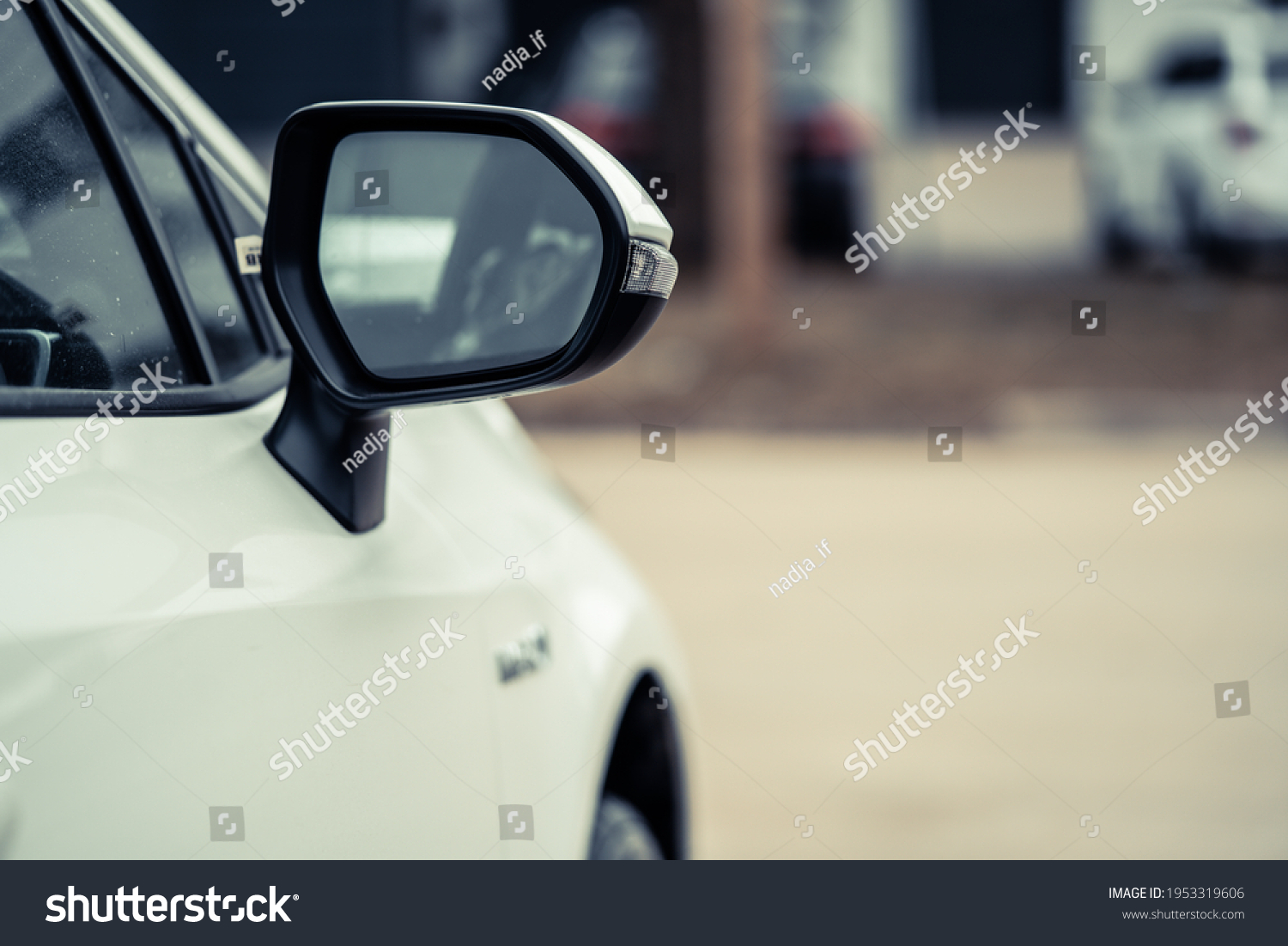 side rear-view mirror on a car. #1953319606