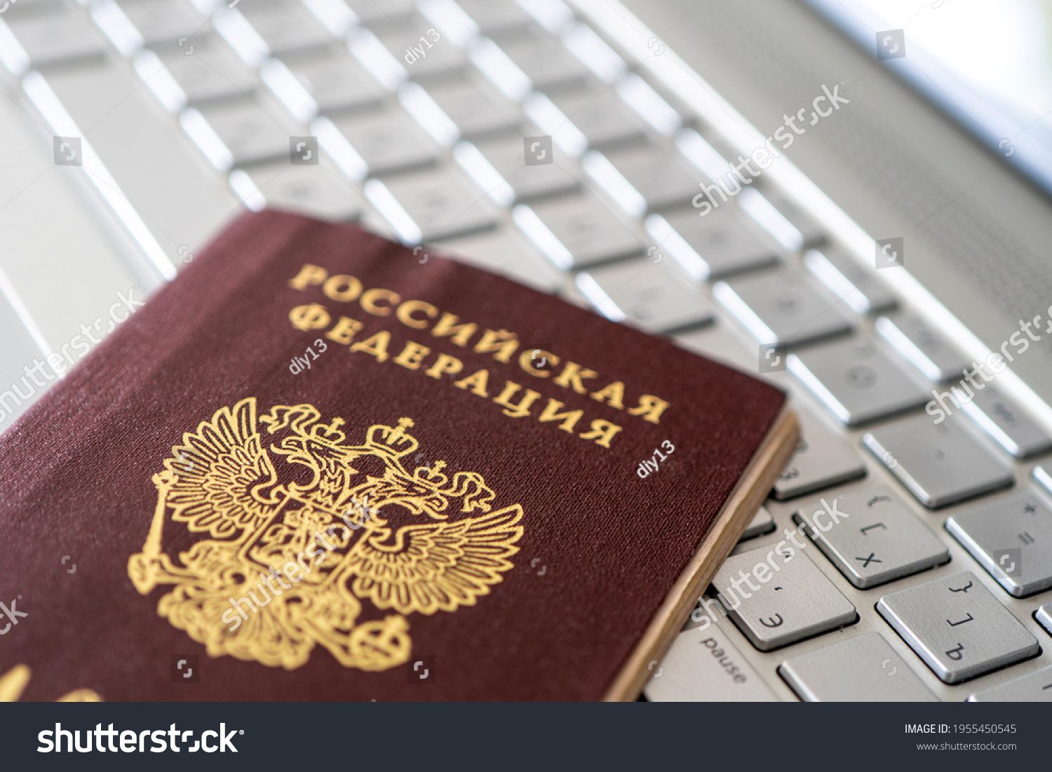 Passport of the Russian Federation on a gray laptop keyboard. Identification of the user on the Internet. Prohibition of access to the Internet without passport data. #1955450545