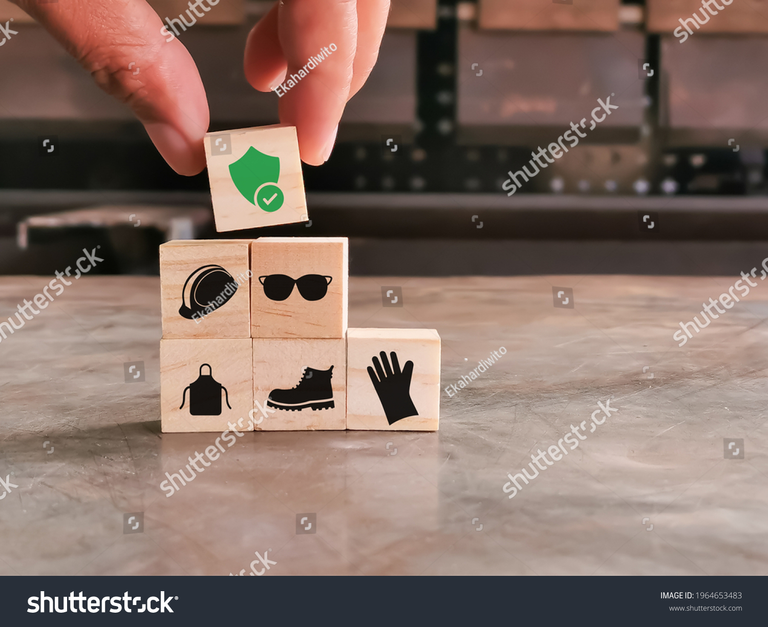 Safety at work concept. Hand putting wooden block with safety icons. #1964653483