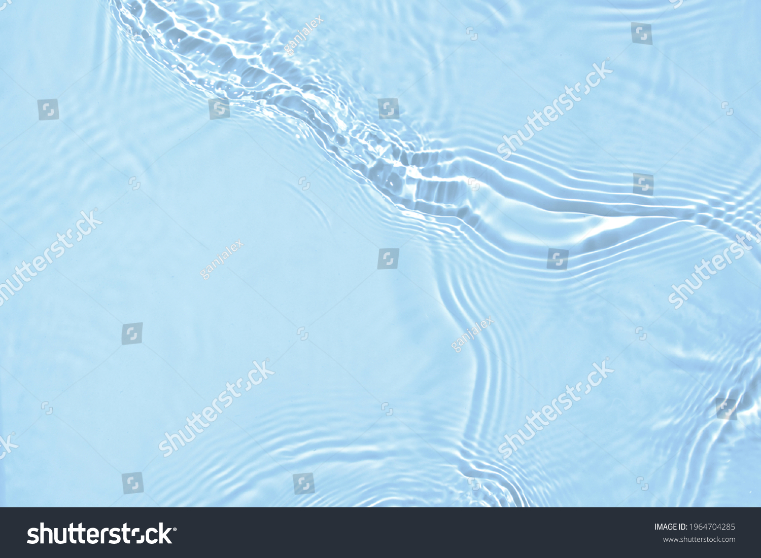 De-focused blurred transparent blue colored clear calm water surface texture with splashes and bubbles. Trendy abstract nature background. Water waves in sunlight with copy space. #1964704285