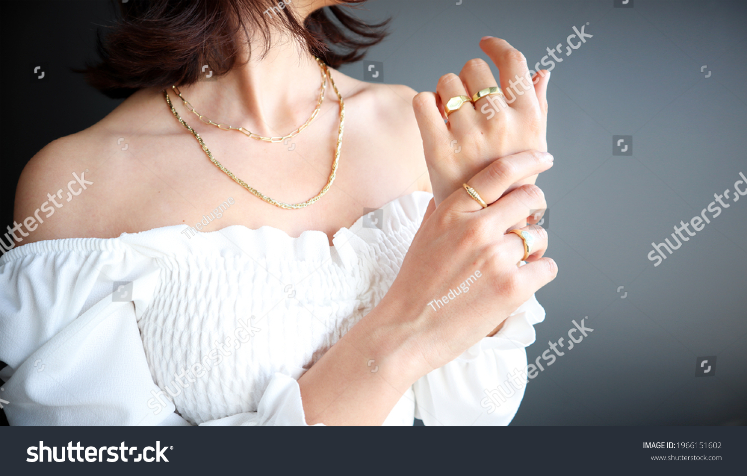 Woman Jewelery concept. Woman’s hands close up wearing rings and necklace modern accessories elegant life style with copy space for text and background.  #1966151602