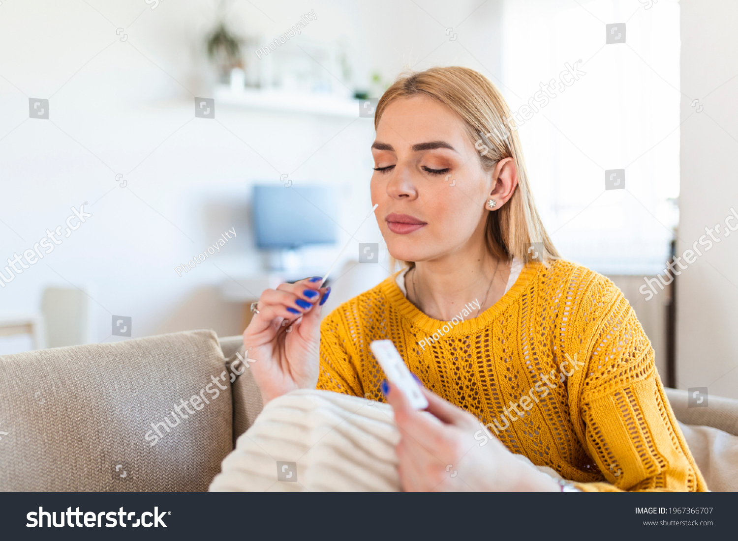 Portrait of relaxed young woman taking a Self-swabbing home tests for COVID-19 at home with Antigen kit. Introducing nasal stick to check the infection of Coronavirus. Quarantine, pandemic. #1967366707