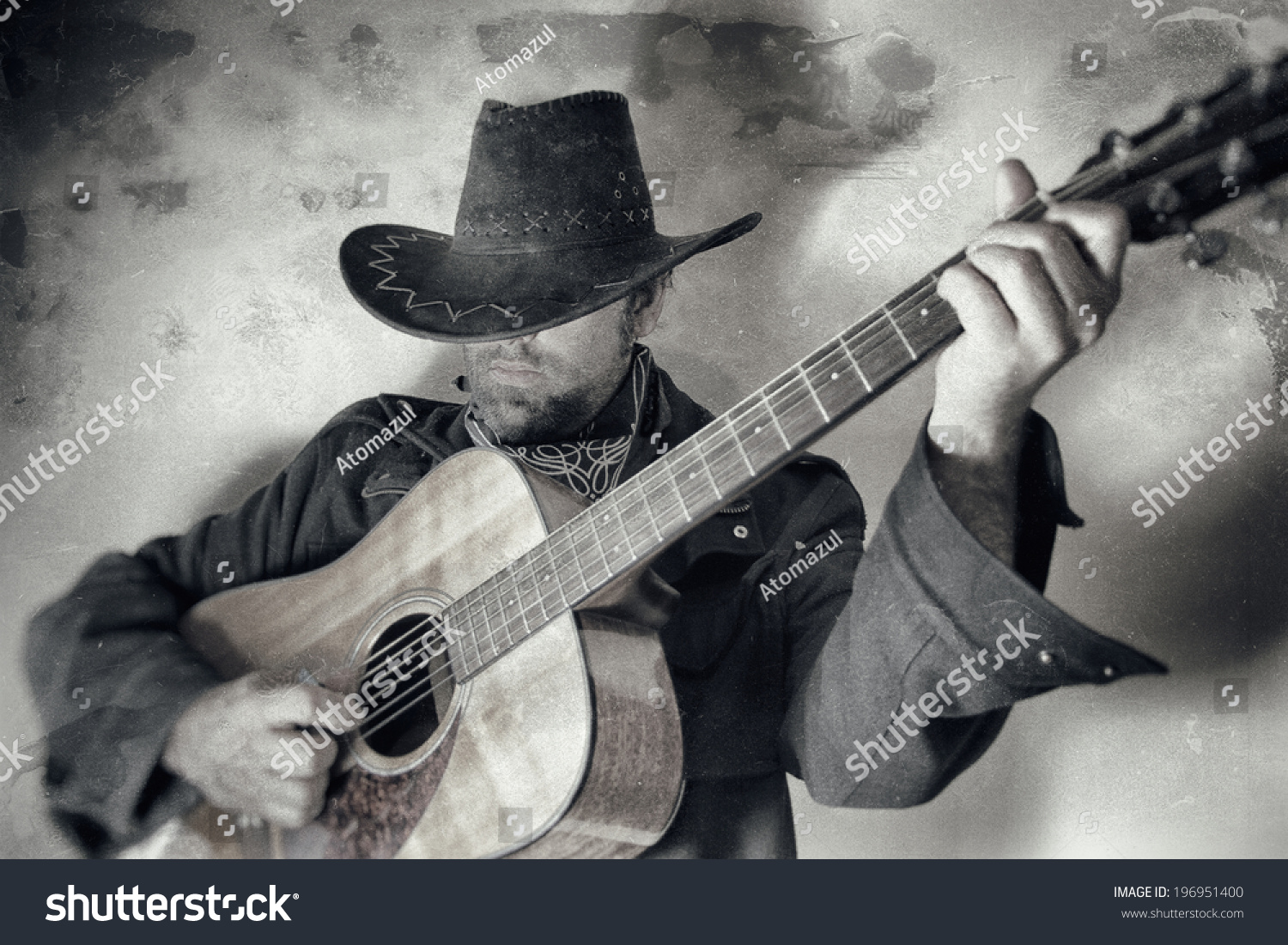 Old West Cowboy With Guitar. A cowboy playing a guitar, edited in vintage film style. #196951400