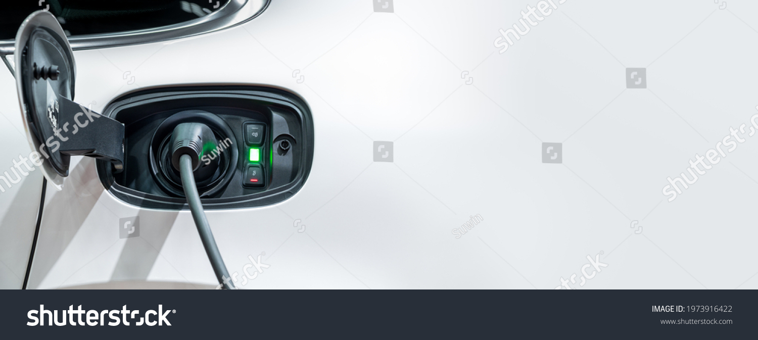 White electric car charging with copy space, Technology electric vehicle concept #1973916422