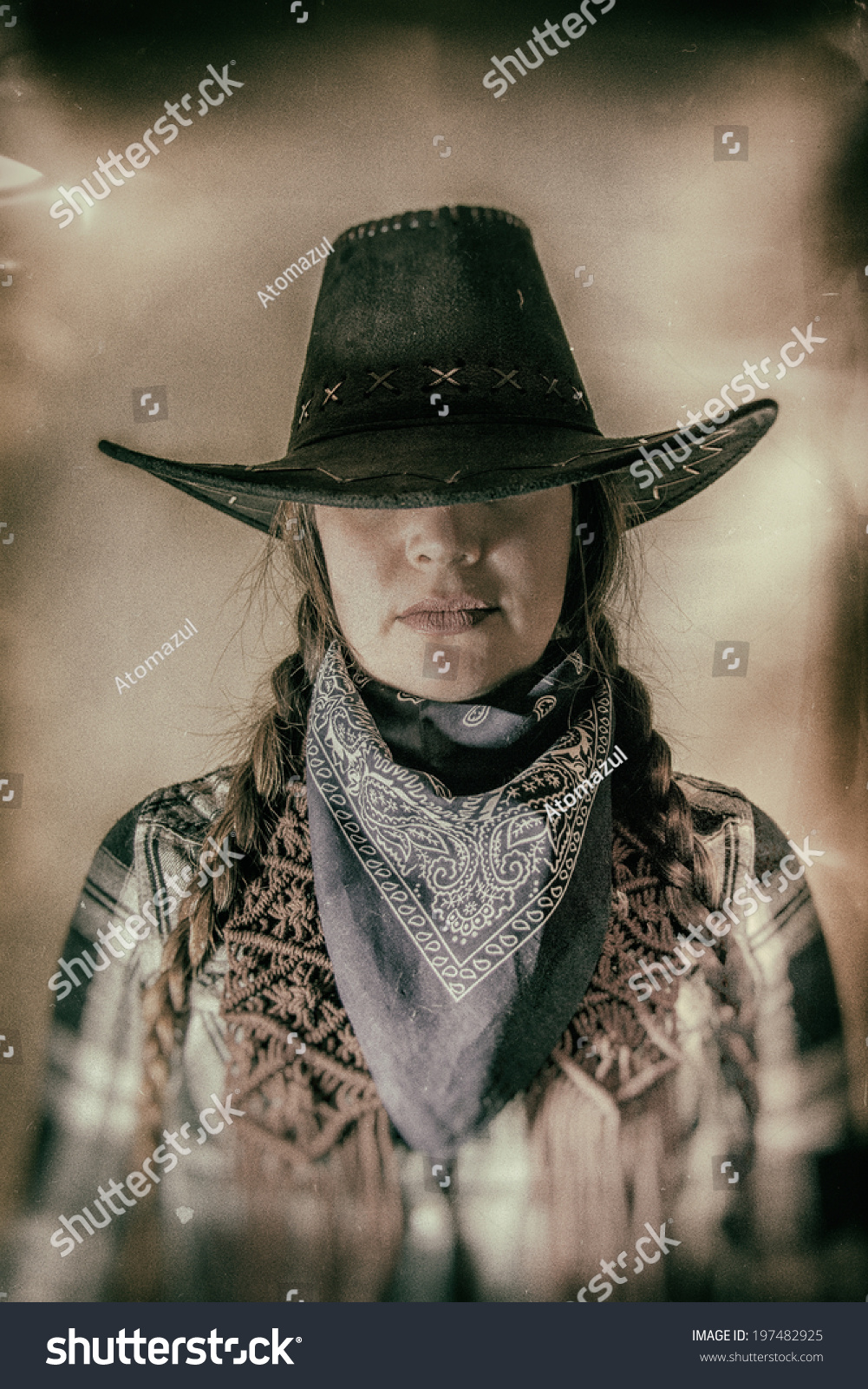 Old West Cowgirl Hat Low Wide. Old west cowgirl with hat low blocking eyes, edited in vintage film style. #197482925