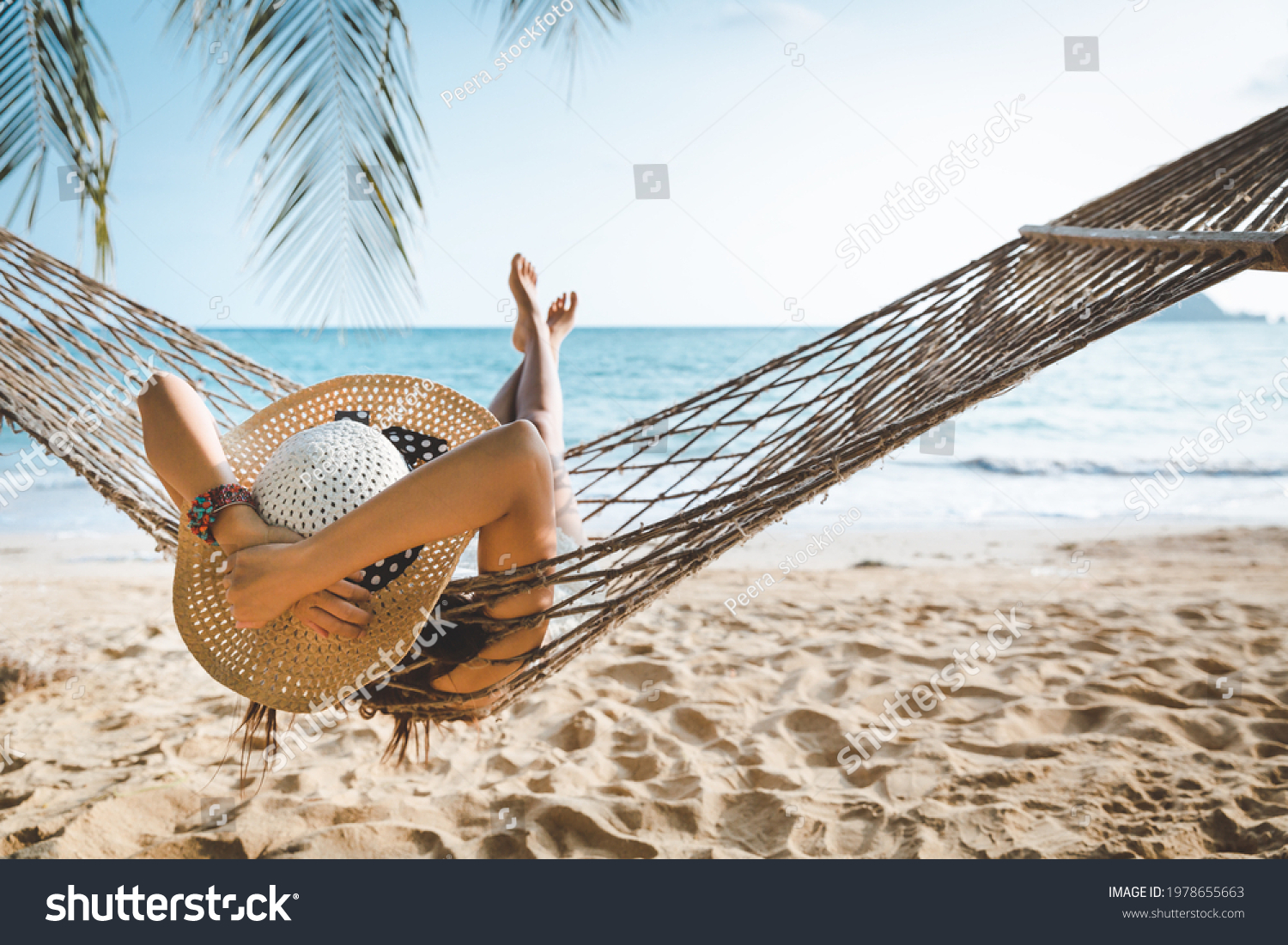 Summer travel vacation concept, Happy traveler asian woman with white bikini relax in hammock on beach in Koh mak, Thailand #1978655663