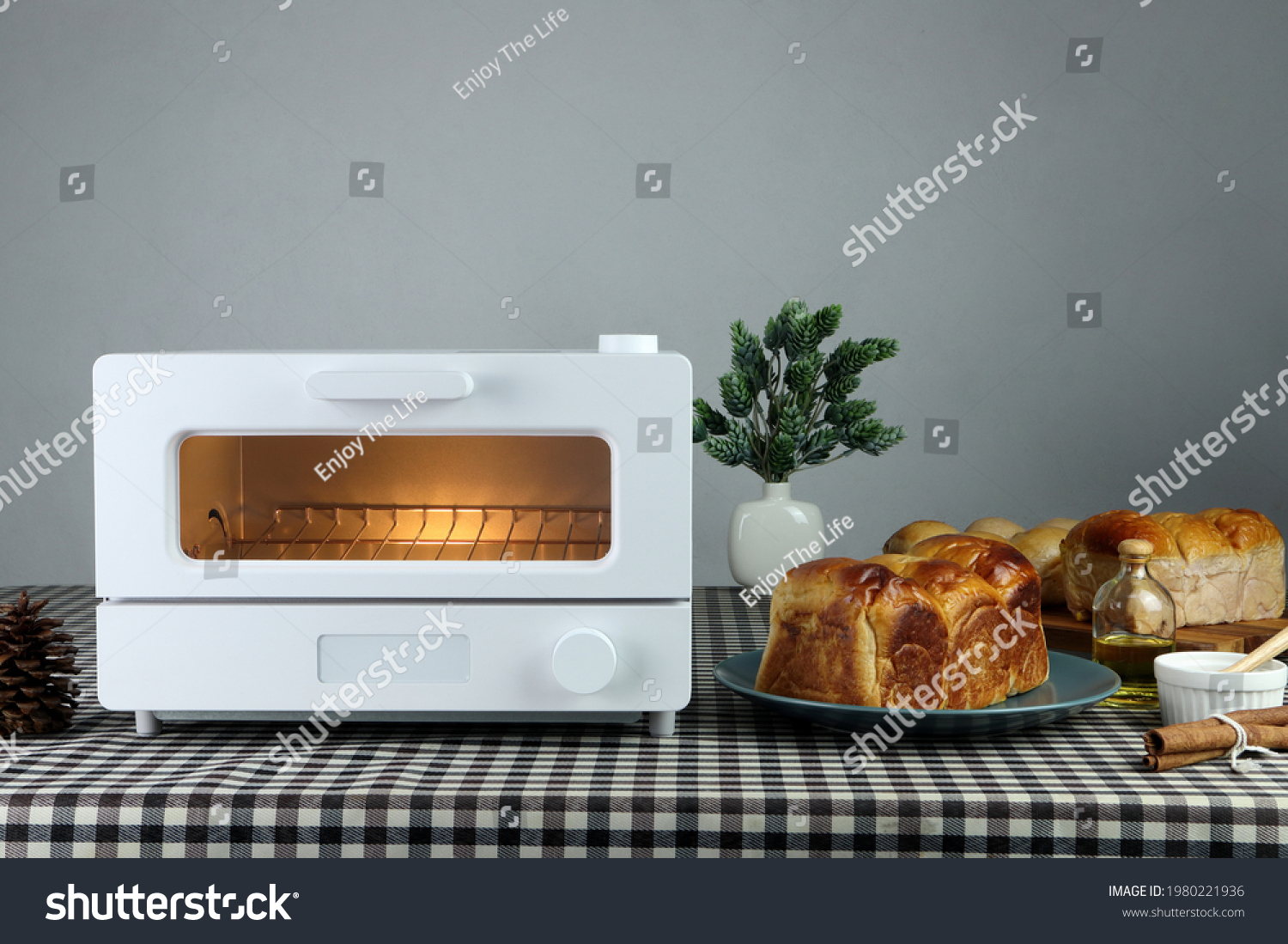 white modern design toaster oven , countertop or convection oven is on the table with homemade sweet potato butter toast breads on grey cement wall background in the kitchen room for breakfast #1980221936