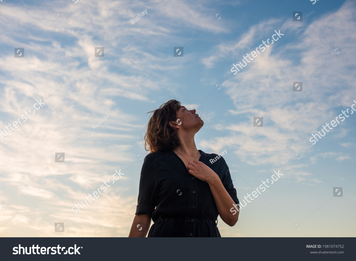 Portrait of woman looking up to the sky #1981074752