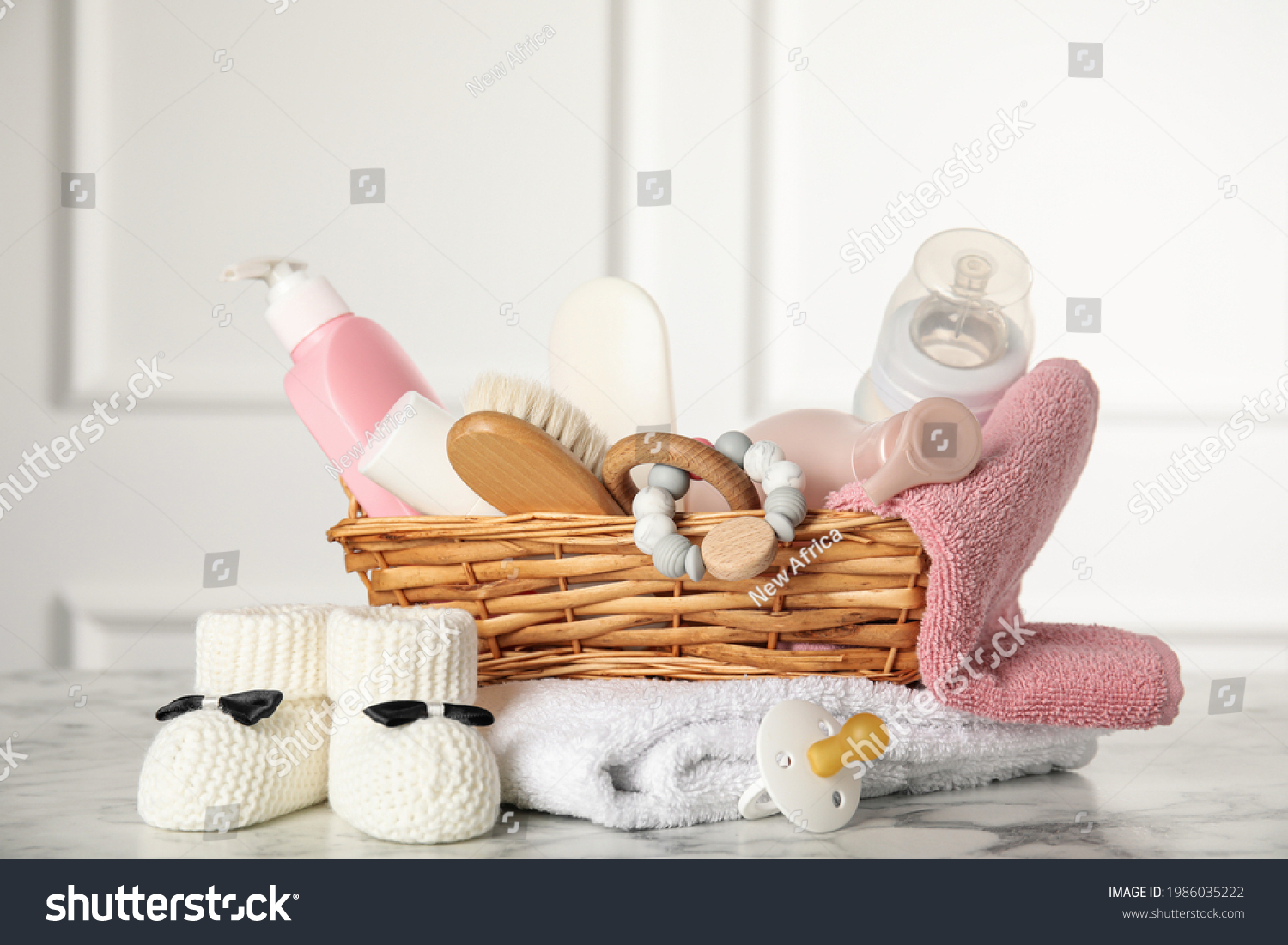 Baby booties and accessories on white marble table indoors #1986035222