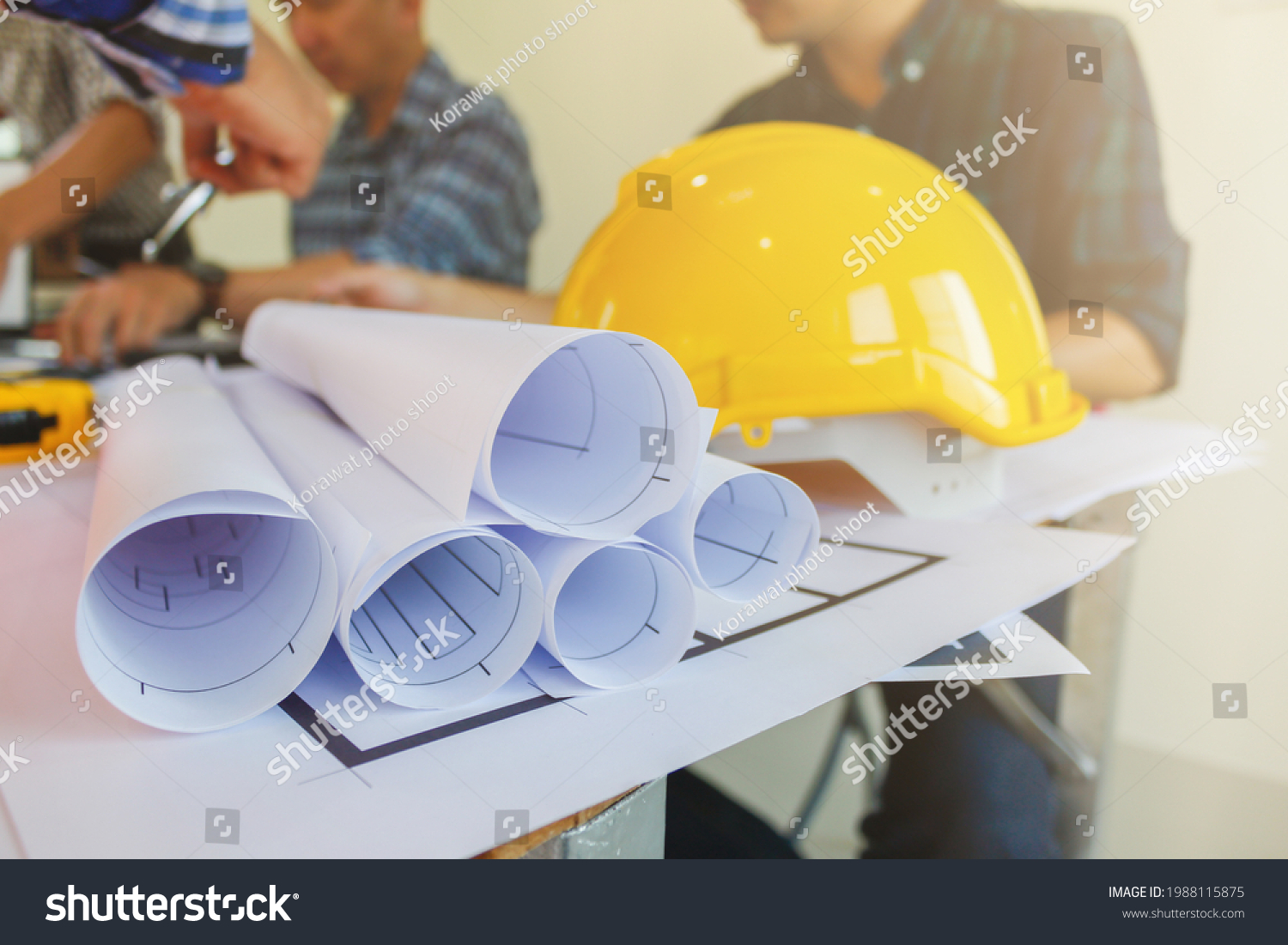 Plans and documents are placed on desks in the engineering team's office to prepare for the meeting of the designers, engineers and foreman teams to supervise the construction work as planned. #1988115875