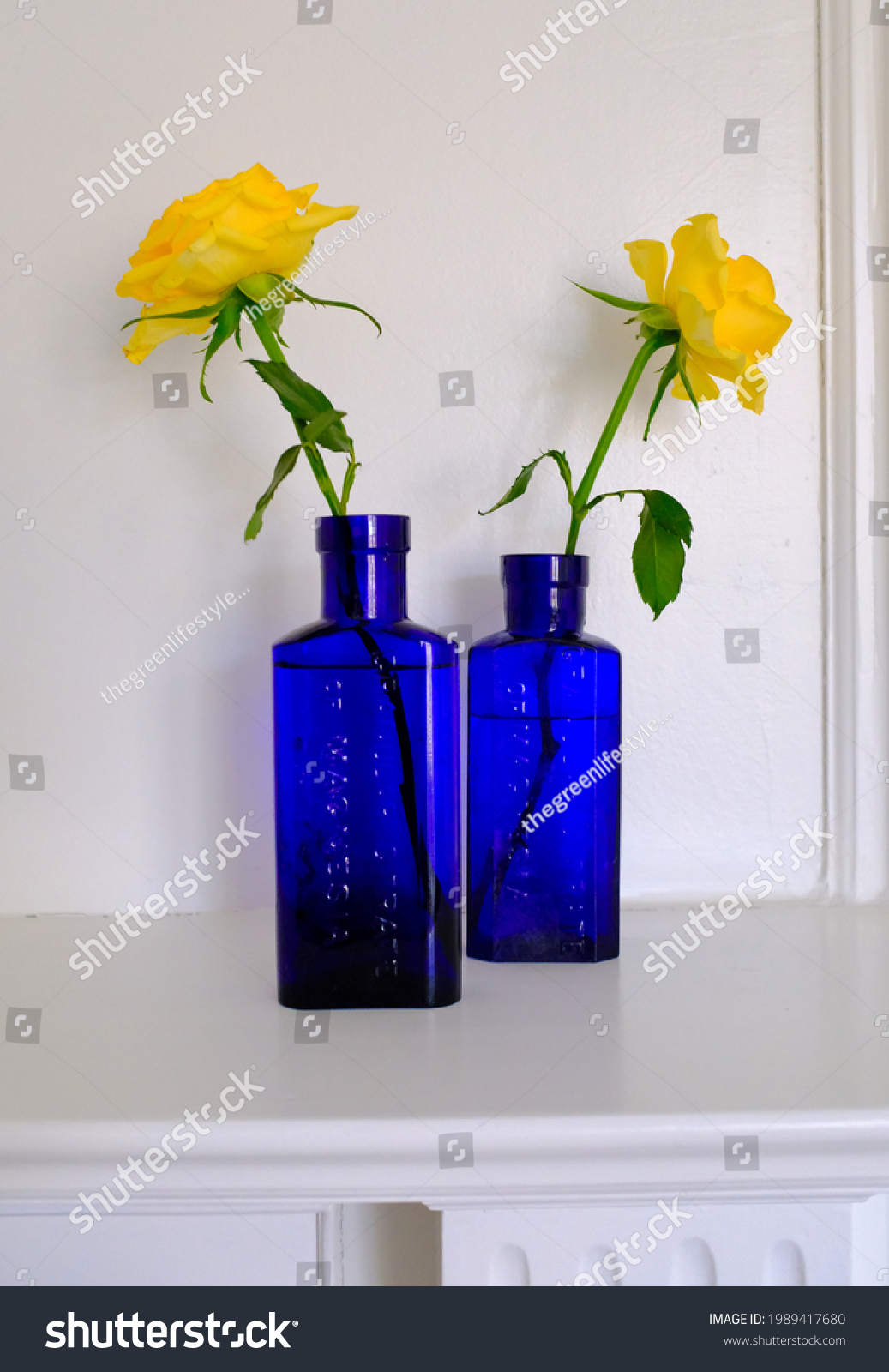Yellow roses in cobalt blue victorian medicine bottles #1989417680