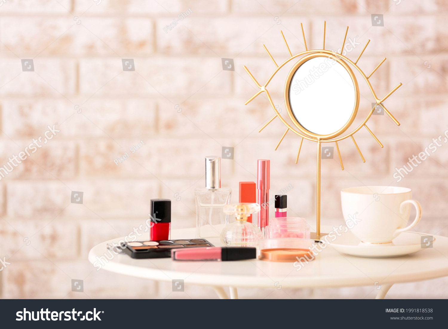 Different cosmetics and mirror on table in room #1991818538