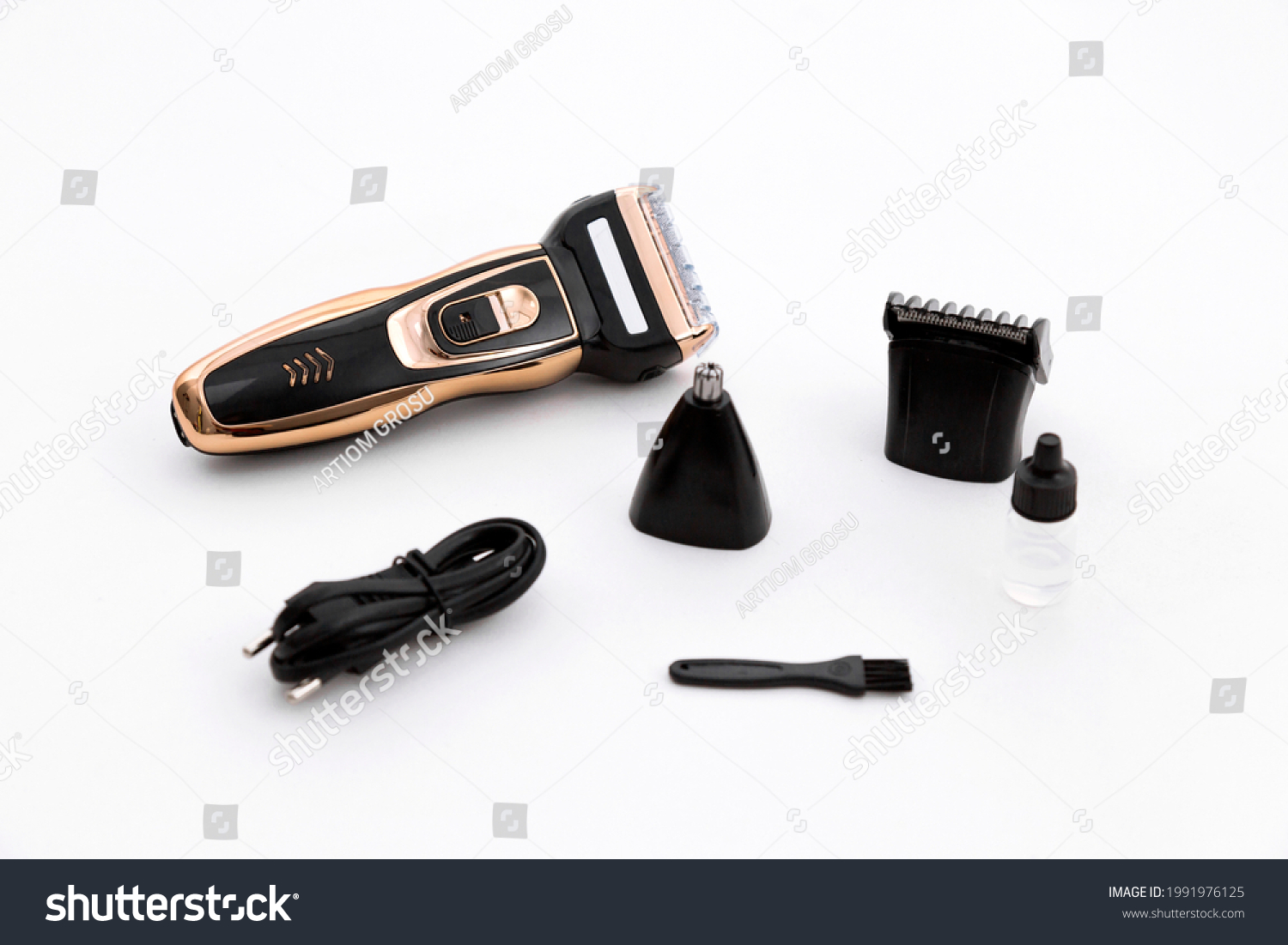 
Multifunctional Gold Razor Trimmer 3 in 1. The electric shaver is equipped with a mesh razor. The shaving head is separated from the face by a mesh. White background. #1991976125