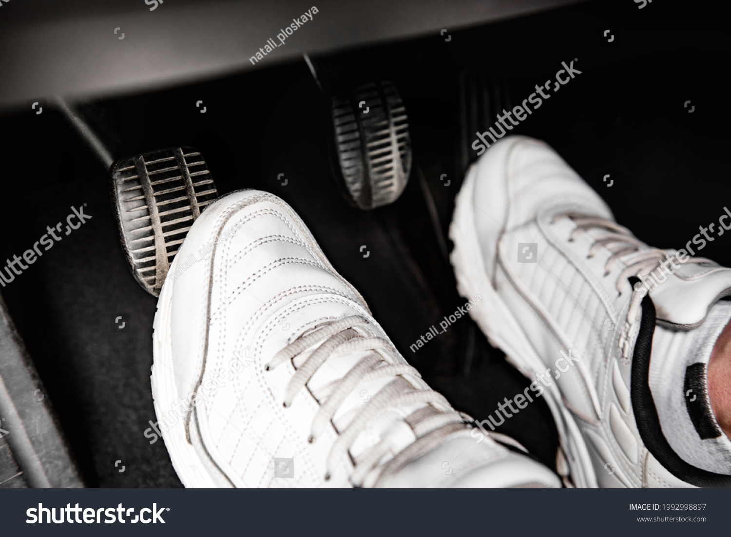 Human feet pressing car pedal. #1992998897