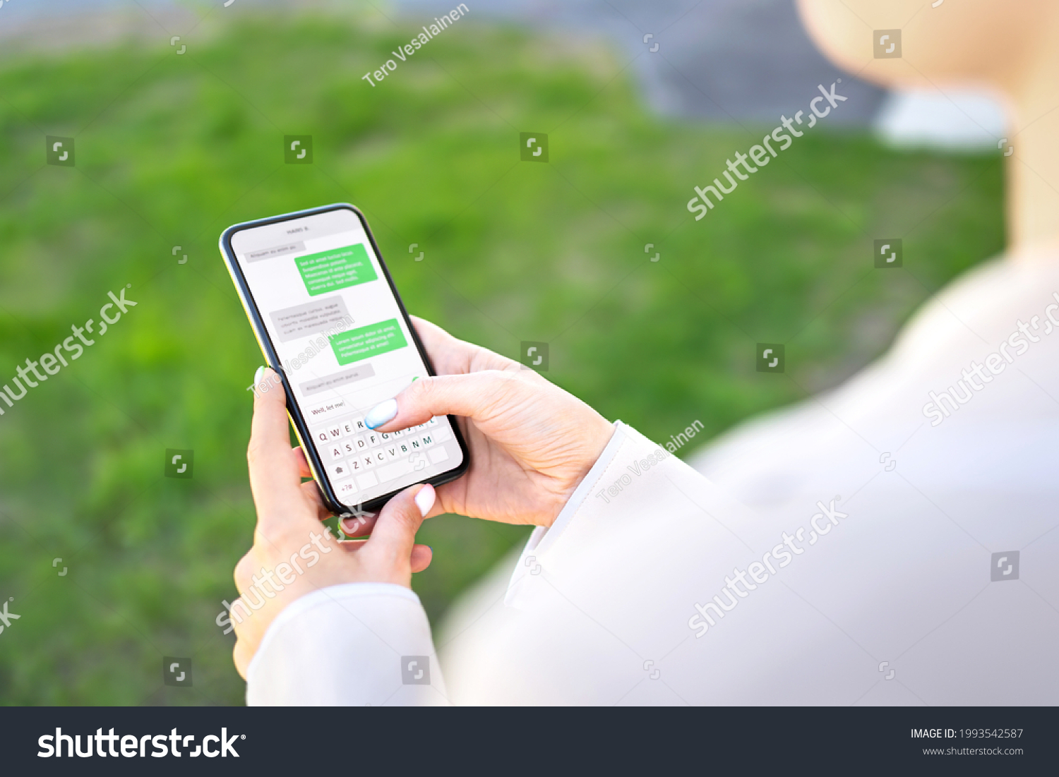 Woman texting with phone outdoors. Text message with smartphone. Digital sms and instant messaging chat. Person using cellphone in park outside in summer. Conversation with boyfriend or friend. #1993542587