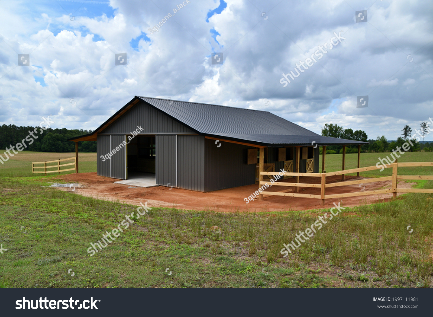 Horse barn built with post frame materials; two lean-to's, two sliding barn doors, six stalls, concrete floor #1997111981