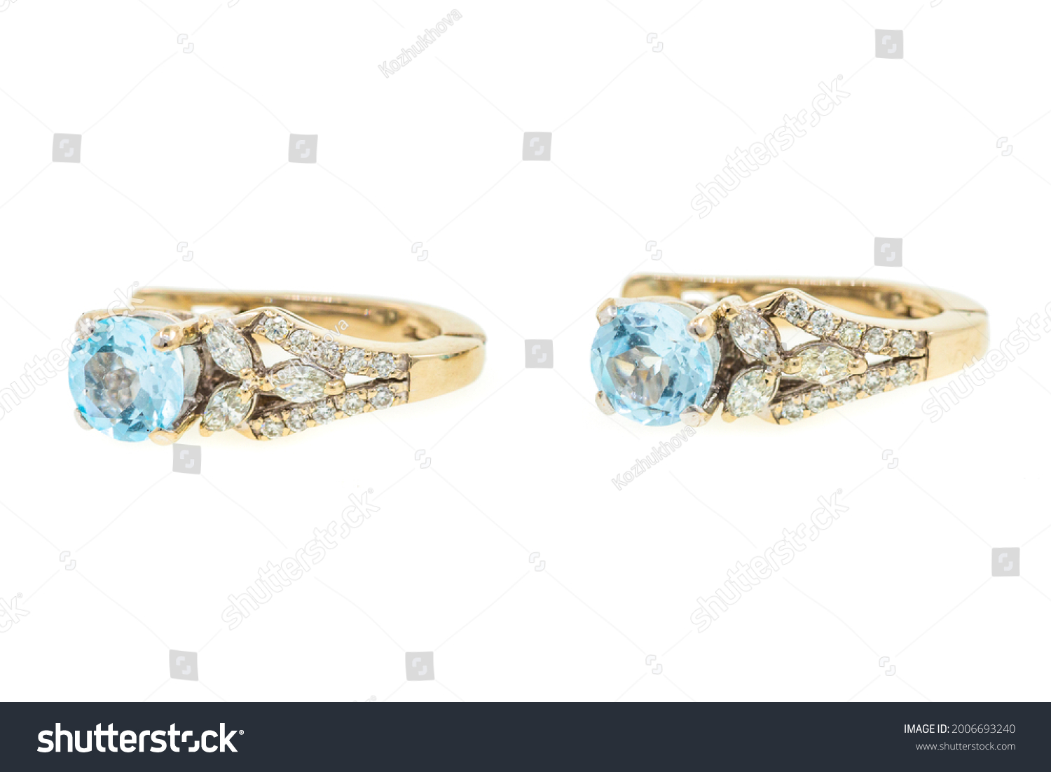 Gold earrings with blue topaz. The jewelry is isolated on a white background. Women's accessory #2006693240