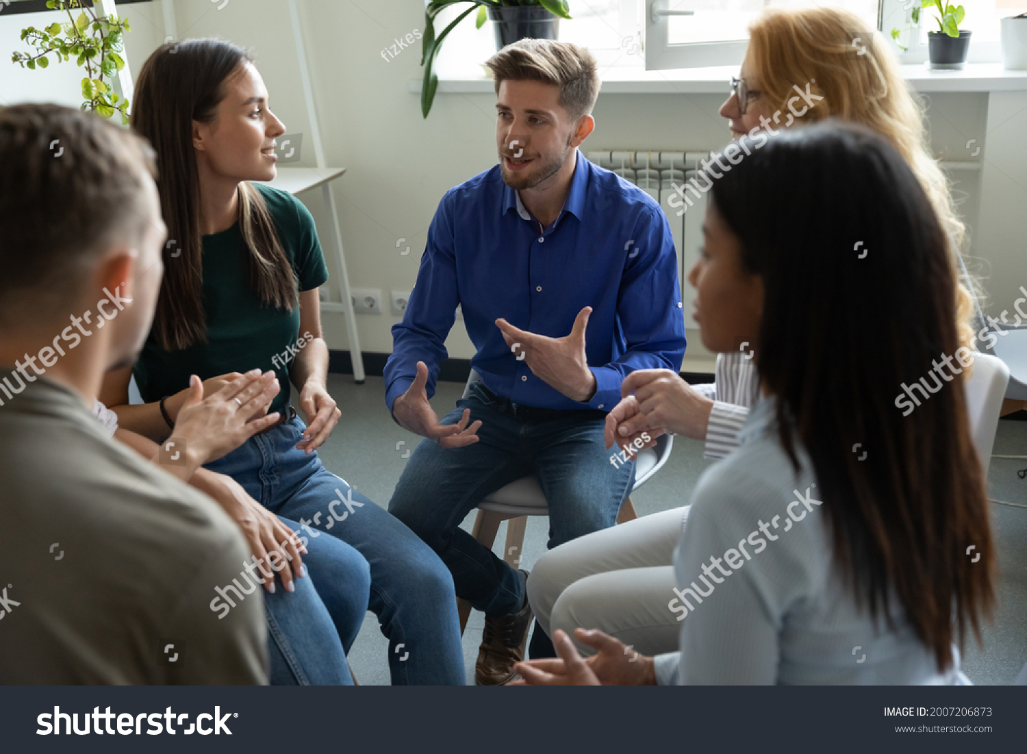 Work addict people talking on group therapy meeting, sitting in circle, discussing addiction, mental health problems. Counselor speaking, giving support and advice to team for successful recovery #2007206873