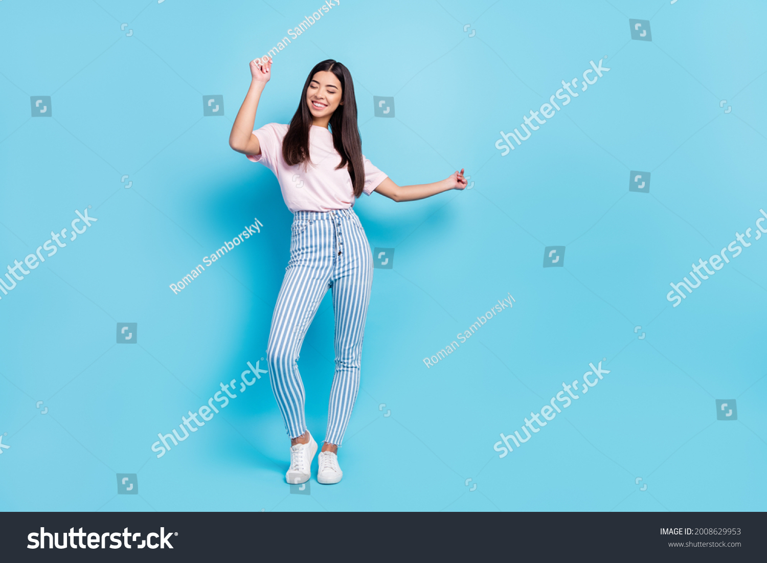 Full length body size view of attractive cheerful slender carefree girl dancing moving isolated over bright blue color background #2008629953