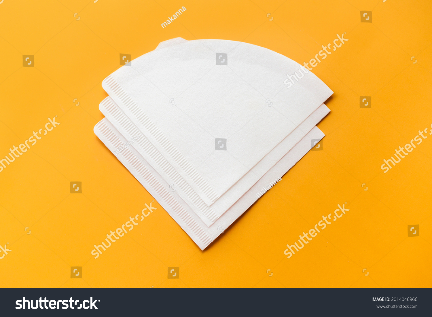 Bleached paper coffee filter isolated on yellow background. Alternative brewing pour over v60 concept. Minimalistic abstract background for store, shop, retail. mock up, top view, place for text #2014046966