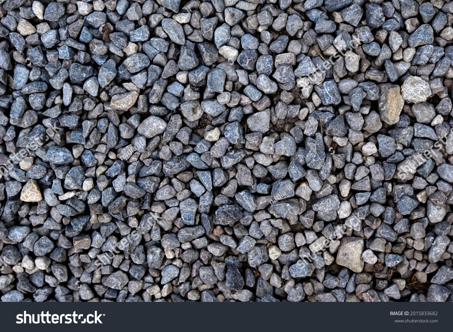 Smooth round pebbles texture background. Pebble sea beach close-up, dark wet pebble and gray dry pebble. High quality photo #2015833682