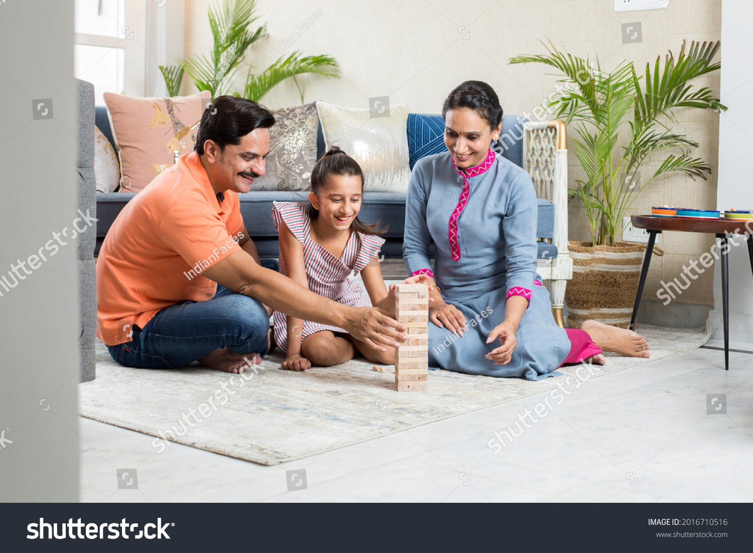 Happy Family sitting On floor Playing With The Wooden Blocks At Home #2016710516