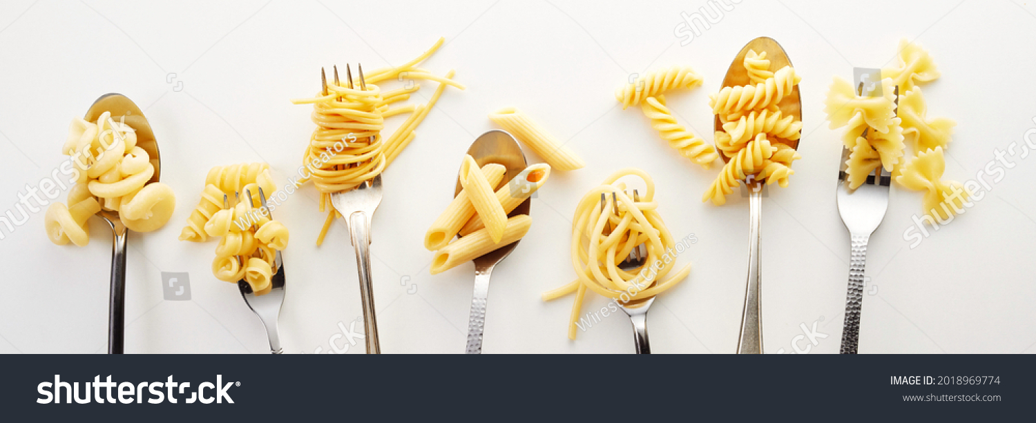 Various types of spaghetti, noodles, and pasta on the forks and spoons in the white background #2018969774